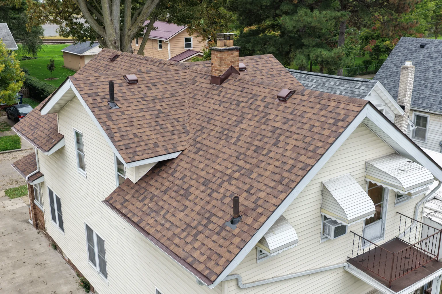 After: a two-story home re-roofed with new architectural shingles, drone view